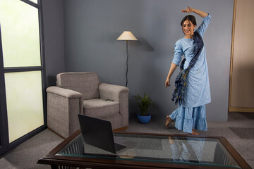 A classical dancer teaching steps in online class.