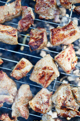 grilled pork skewers with smoke outdoors