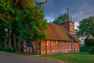 Fototapeta na wymiar Church in the village of Wróblewo on the Motława River near the city of Gdańsk, built in the 16th century. Catholic Church of the Blessed Virgin Mary. (formerly Evangelical). The building was made of 