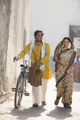 A RURAL HUSBAND AND WIFE HAPPILY WALKING TOGETHER