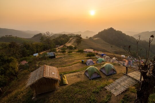 The sunset scenery including camping Tents on Doi Samer Dao Mountain at twilight, Nan Province, Thailand. Using warm tone mood