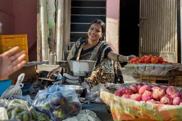 A RURAL WOMAN HAPPILY SELLING VEGETABLES