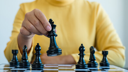 Hand of businesswoman moving, chess in competition shows leadership, followers, and business success strategies