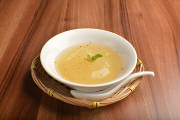 chilled sweet lemongrass jelly pudding with gui hua flower dessert in bowl on wood table asian dessert halal menu