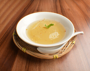 chilled sweet lemongrass jelly pudding with gui hua flower dessert in bowl on wood table asian dessert halal menu