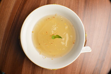 chilled sweet lemongrass jelly pudding with gui hua flower dessert in bowl on wood table asian dessert halal menu