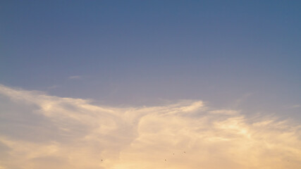 Naklejka na ściany i meble A radiant sunset on a soft pastel sky in the evening