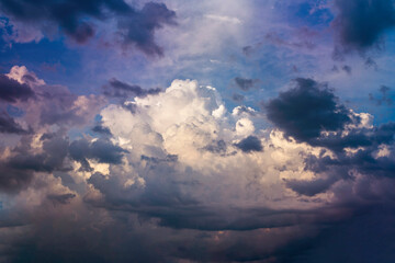 Beautiful dramatic clouds on a background of blue sky before the summer storm. Powerful sky background with a big cloud