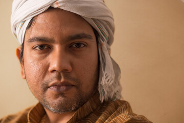 CLOSE SHOT OF A RURAL MAN WITH DHOTI WRAPPED AROUND HIS HEAD