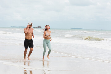 A man and A woman runner in sportswear outdoor running at the seaside