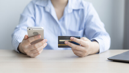 Women use smart phone to register online purchases using credit card payments, Technology for the use of smartphones for business or online financial transactions, Shopping online and banking online.