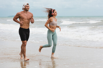 A man and A woman runner in sportswear outdoor running at the seaside
