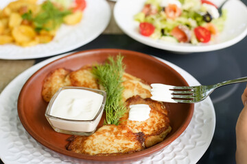 Potato pancakes with sour cream and herbs