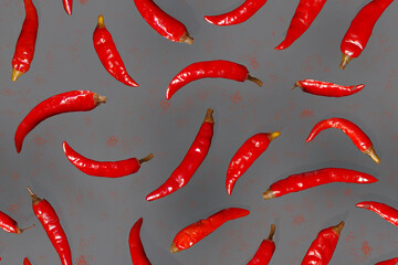 Seamless pattern with red chili peppers on a gray background.