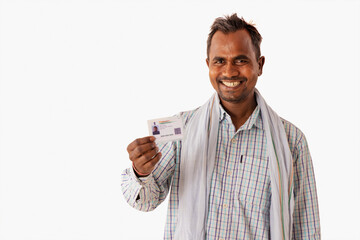 A MANUAL LABOURER HAPPILY SHOWING AADHAR CARD IN FRONT OF CAMERA