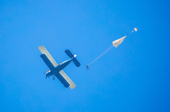 Skydiving. Parachutists Jump From A Flying Plane In The Air. Extreme Sport And Entertainment.