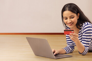 A TEENAGER USING DEBIT CARD TO DO ONLINE TRANSACTION AT HOME