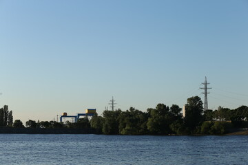 Landscape with sea, forest and power lines