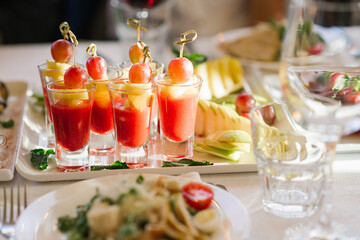 Beautiful and delicious snacks in glass in the serving of a festive banquet at a wedding