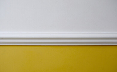 Interior image of white dado rail with yellow below and white above