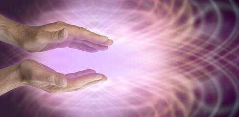 Sending out beautiful magenta healing energy - mature male parallel hands with voilet ray energy...