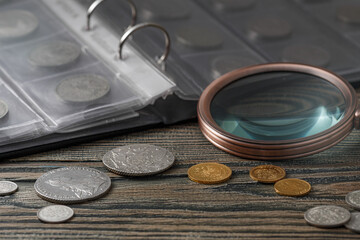 Numismatics. Old collectible coins on a wooden table. Numismatics. Old collectible coins made of...