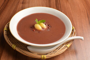 
hot cook red bean paste sweet dessert in bamboo basket on wood table asian dessert halal menu