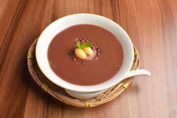 
hot cook red bean paste sweet dessert in bamboo basket on wood table asian dessert halal menu