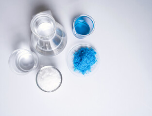 Inorganic chemical on white laboratory table. Copper(II) sulfate, Microcrystalline wax, alcohol....