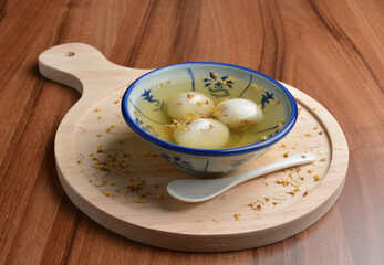 boiled glutinous rice ball (tang yuan) with peanut and sesame in sweet gui Hua flower soup dessert...
