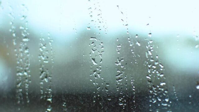 raindrops fall on the window. rain on the glass close-up.