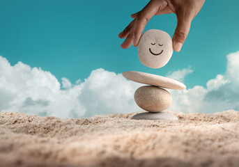 Enjoying Life Concept. Harmony and Positive Mind. Hand Setting Natural Pebble Stone with Smiling...