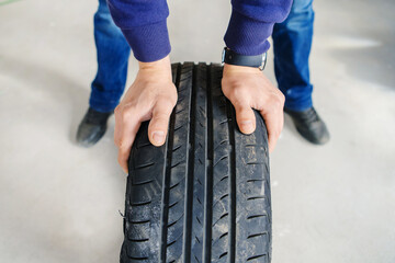 Car tire. Replacement of old wheels with worn out tread in a car workshop. Beyond recognition. Foreground