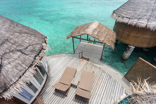 Water villas with deckchairs on sunny day