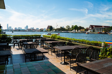 Fototapeta premium Empty table restaurant bar water front view temple of dawn Wat Ph