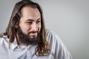 portrait of a young middle eastern businessman with beard and long hair