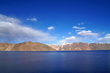 Landscape Lake Nature Scene of Pangong tso or Pangong Lake with Snow mountain background is best famous destination at Leh Ladakh ,Jammu and Kashmir , India - Blue nature travel  Background - travel
