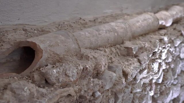 Ancient walls with remains of water channels found in archaeological excavations under the acatterale of San Pietro Apostolo. Isernia, Molise