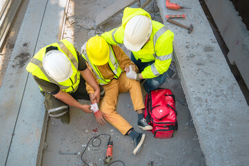 Construction worker has an accident at a construction site. Emergency help engineers provide first...