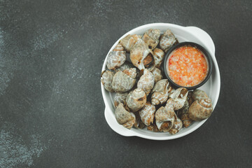Roasted spotted Babylon in the bowl served with Thai seafood sauce