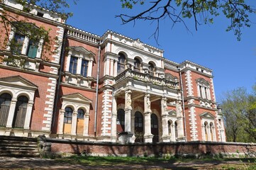 An ancient building. Manor house of a noble estate made of red bricks with white trim. The main...