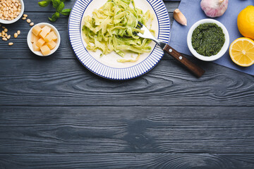 Plate with tasty pesto pasta on table
