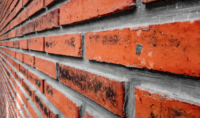 the walls of the house made of red bricks are neatly arranged