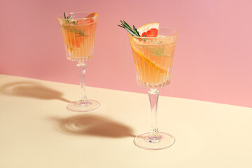 Glasses of tasty grapefruit cocktail on color background