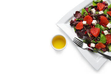 Plate with tasty grapefruit salad on white background