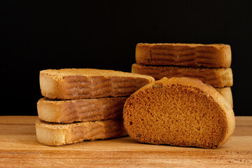 Sweet fried croutons close-up on a wooden board