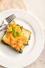 Plate with tasty green lasagna on table
