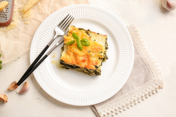 Plate with tasty green lasagna on table
