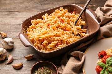 Baking dish with healthy pasta on table
