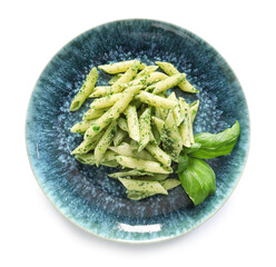 Plate with tasty pesto pasta on white background